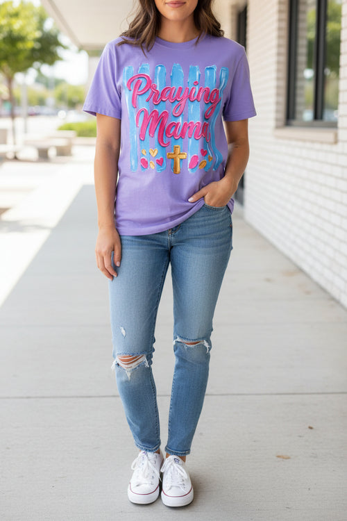 Purple t-shirt with 'Praying Mama' text and graphics on a white background